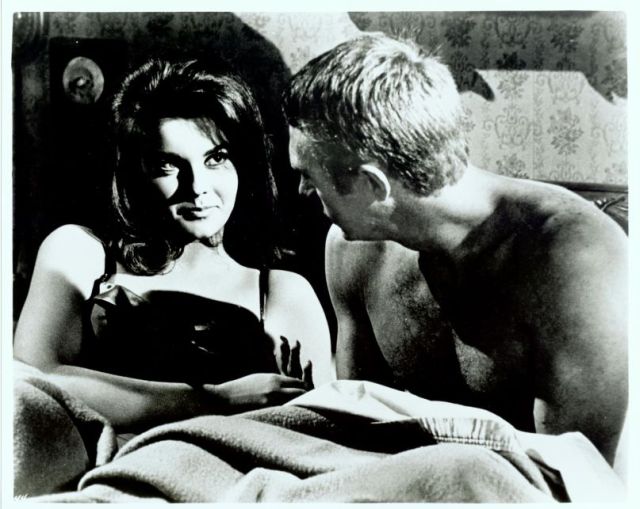 Melba (played by Ann-Margret) 
sneaks into bed with Eric (McQueen).